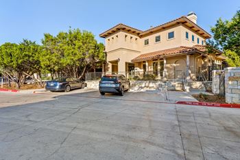A house with a car parked in front of it. at Bridge at Heritage Woods, Austin, TX, 78753